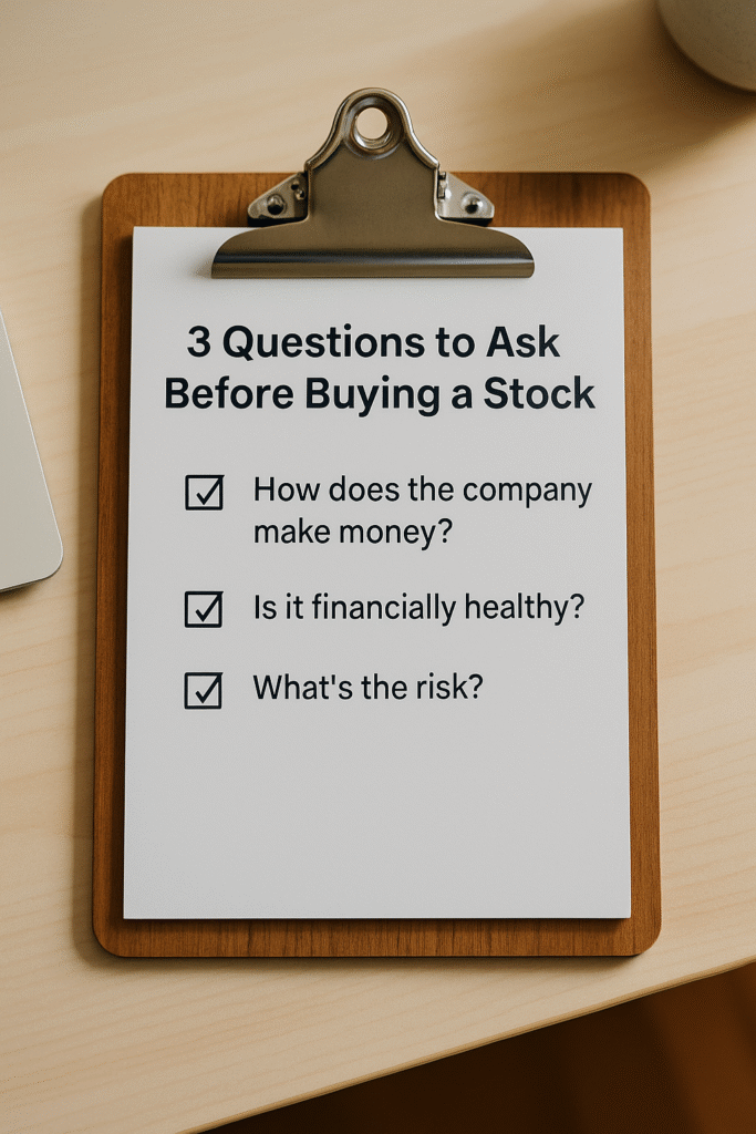 A wooden clipboard on a light desk holding a white notepad titled “3 Questions to Ask Before Buying a Stock,” with three checklist items: how the company makes money, financial health, and risk. Soft natural lighting and a minimal, professional workspace aesthetic.